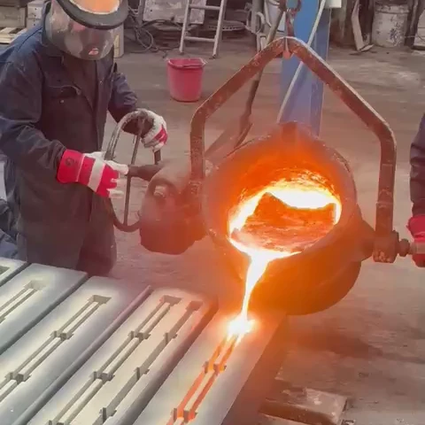 Foundry workers pouring molten iron